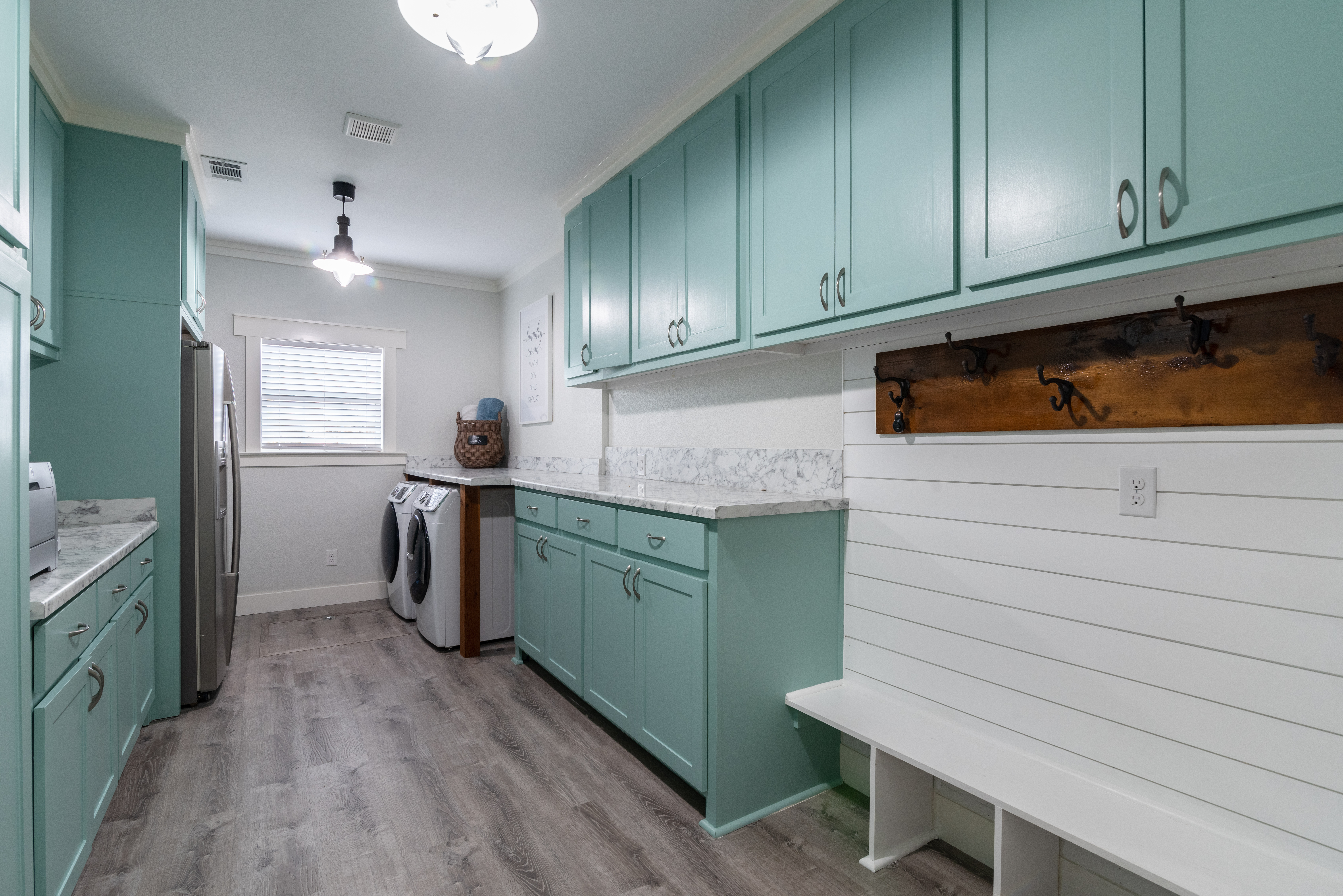 Mint green and white laundry room with mudroom, counter space, oversized | Carpet Barn