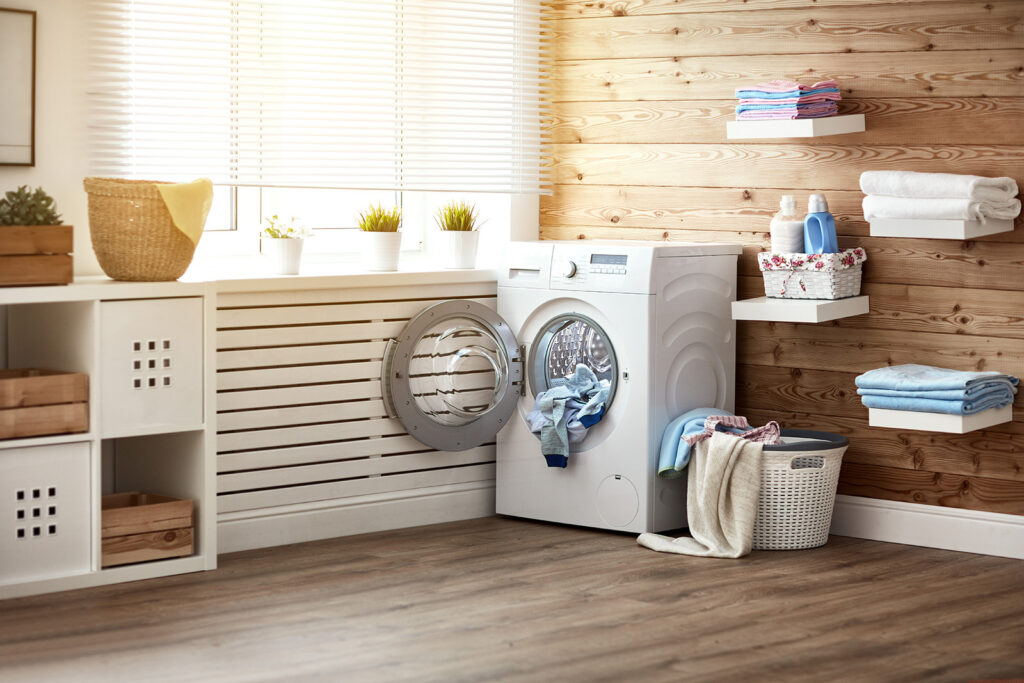 Interior of real laundry room with washing machine at window at home | Carpet Barn