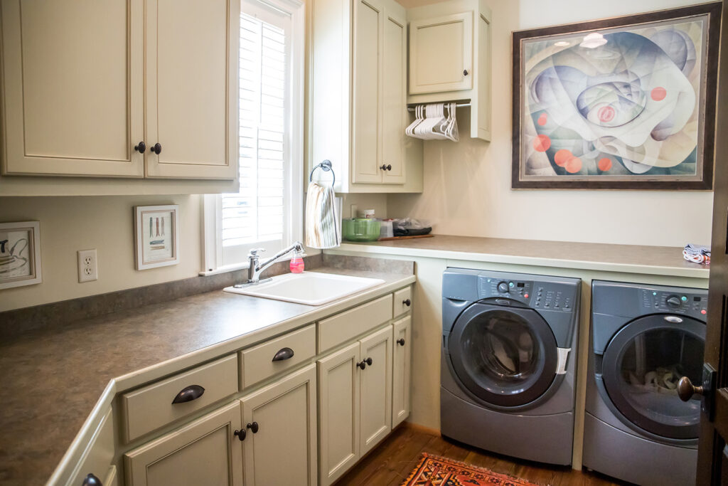 Large cream white laundry room with a window and natural light | Carpet Barn